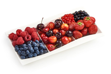 A mixed arrangement. Assorted berries including strawberry, cherry, blueberries, raspberries, black currant and red currant, isolated on white background.
