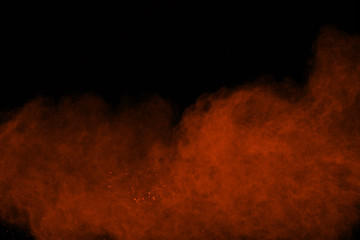 The explosion of color powder. Freeze motion of color powder exploding on black background.