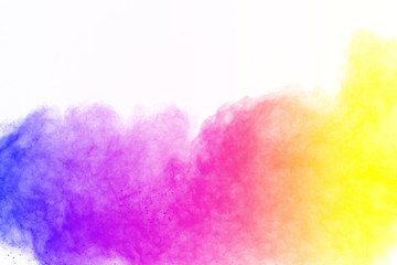 The explosion of colorful powder. Freeze motion of color powder exploding on white background.