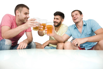 Friends drink beer and have fun sitting at the table on an isolated white background