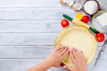 raw base of pastry for baking in a baking dish