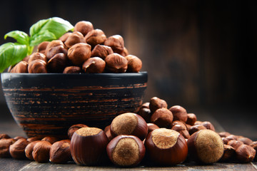 Bowl with hazelnuts on wooden table.