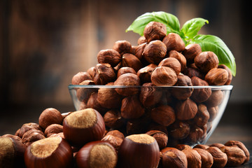 Bowl with hazelnuts on wooden table.