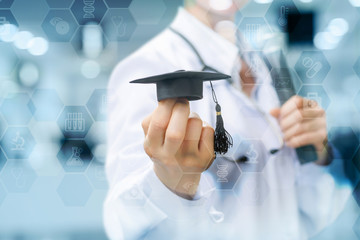 Physician lecturer shows academic hat.