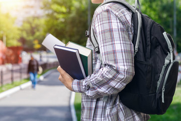 Student with textbooks and backpack.