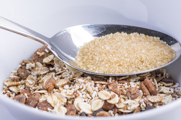 a spoonful of brown sugar on a mountain of chocolate muesli