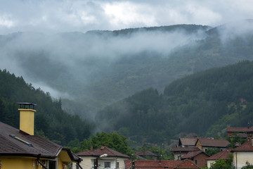 Fototapeta na wymiar Misty landscape of Osogovska mountain, village of Slokoshtitsa, Bulgaria.