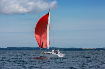 Sailing boat in the sea. Red sails