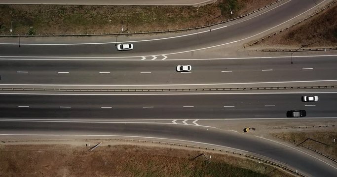 Summer aerial footage of transport junction, traffic cross road junction day view from above with circle road. Top down view of traffic jam.