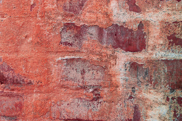 red brick wall during the day in the city
