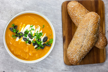 Healthy food - sweet potato cream soup with pumpkin seeds and parsley. Top view