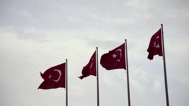 4 Turkish flags waving on the flagpoles.