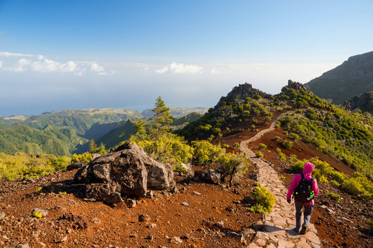 Young woman hiking on path to Pico Ruivo, highest peak of Madeira island, Portugal
