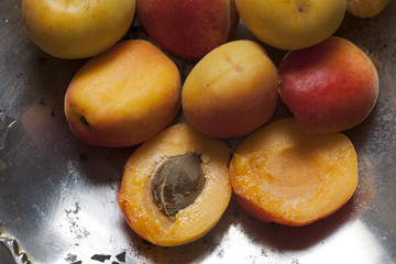 Closeup of apricot in a silver plate; top view.