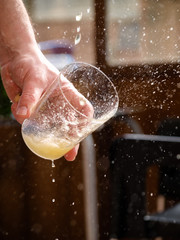 Man hand holding a glass of asturian, spanish apple cider