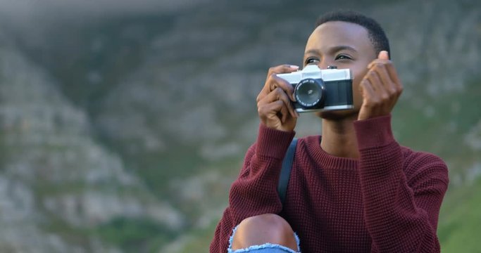 Woman clicking photo with camera 4k