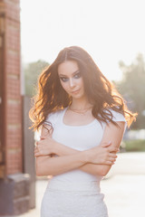 Girl with long hair in elegant white dress