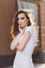 Girl with long hair in elegant white dress