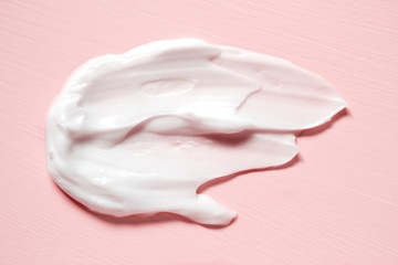 Smear of natural moisturizer in pink background. Cream, Lotion for face or body. Skin care.