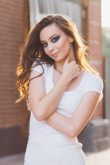 Girl with long hair in elegant white dress