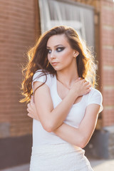 Girl with long hair in elegant white dress