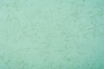 texture of the surface of the wall covered with decorative plaster of the woodworm type