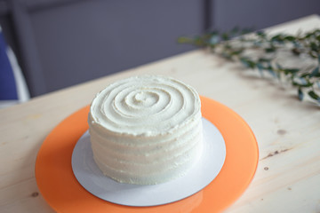 White sponge cake on wooden bright table