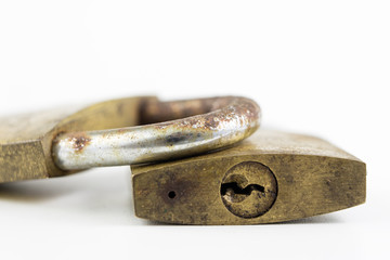 Brass padlock on a white table. Accessories for locking and securing against burglary.