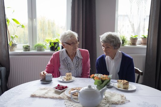 Senior friends interacting witch each other while having