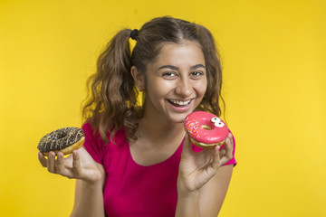 Cheerful Indian girl holding sweet donuts. 