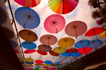 Fototapeta na wymiar street decoration with bright umbrellas against the sky