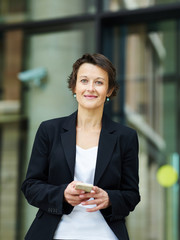 Smiling executive woman on street
