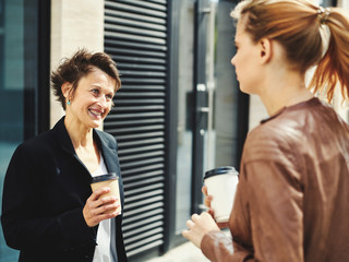 Cheerful adult woman with young colleague