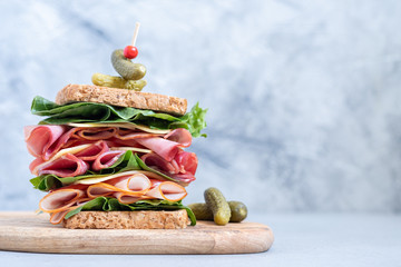 Big sandwich with ham, deli meat and vegetables