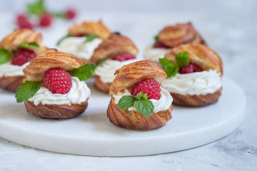 Obraz na płótnie Canvas Raspberries Profiteroles with White Chocolate cream