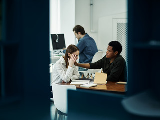 Multiracial students sitting in library