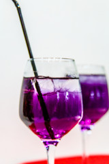 Purple or blue cocktail poured into the glass.