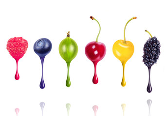 Colored drops of paint flow from different berries, conceptual image isolated on white background