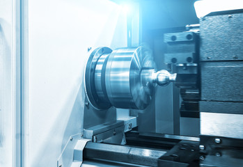 CNC lathe machine Turning machine cutting the metal screw thread part .Hi-precision CNC machining concept.
