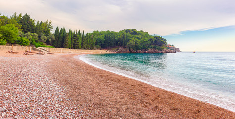Pebble beach on Adriatic sea, near the Sveti Stefan island in Montenegro, gorgeous summer seascape and nature landscape