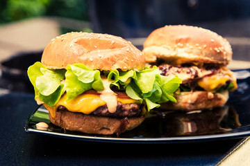 Cheeseburgers on a plate.