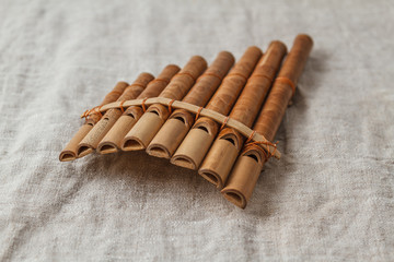 Wooden flute on grey linen tablecloth