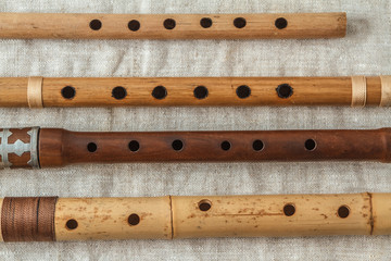 Wooden flute on grey linen tablecloth