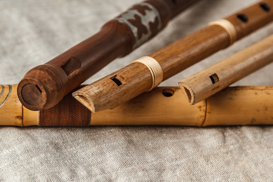 Wooden flute on grey linen tablecloth
