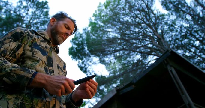 Man holding hunter knife in the forest 4k