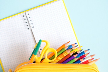School accessories on soft blue background. Back to school concept. Creativity for kids. Colorful...