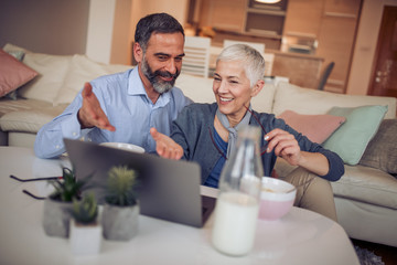 Mature couple using laptop