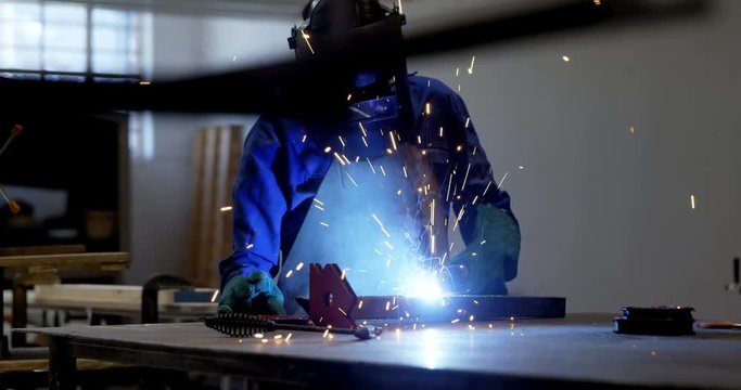 Female welder using blow torch on a rod 4k
