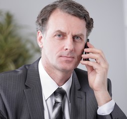 Businessman having phone call conversation at workplace