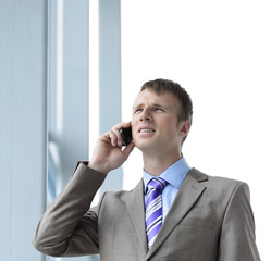 Businessman at the window talking on the phone